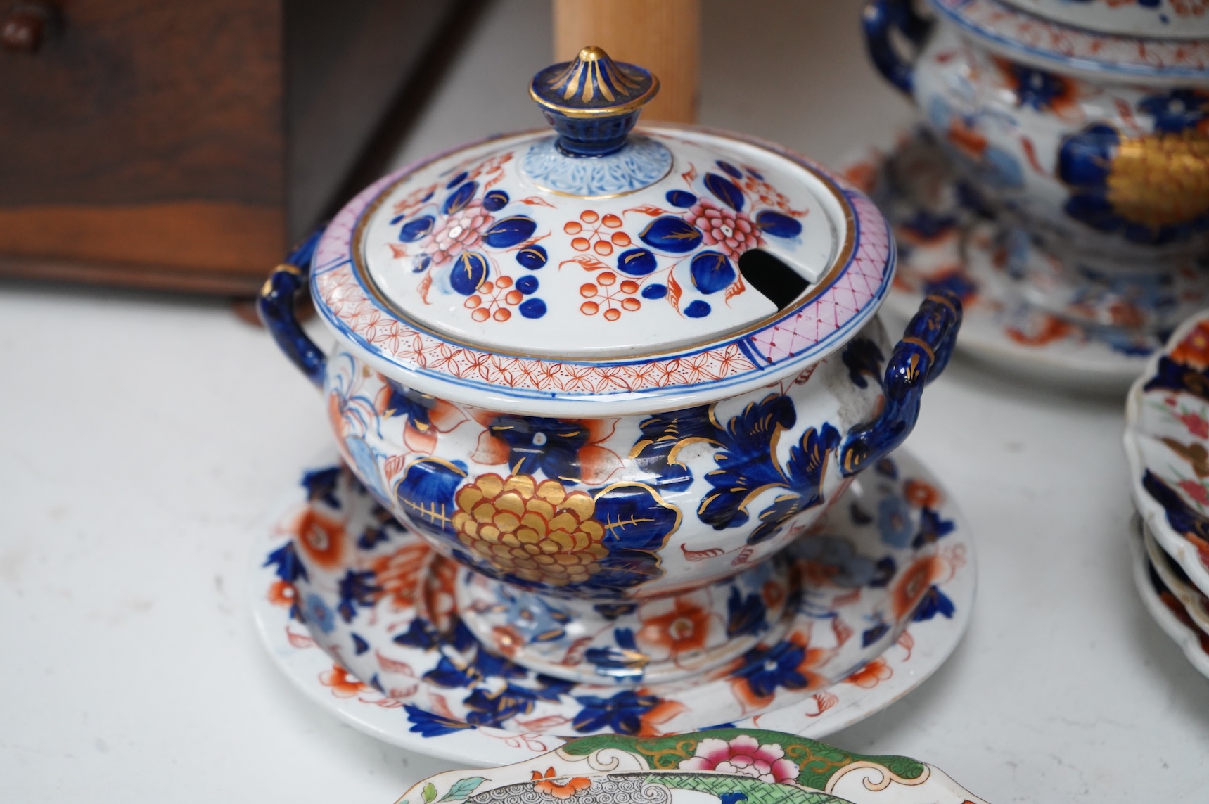 A collection of 19th century English ironstone china to include two pairs of sauce tureens, covers and stands, one marked Masons, various side plates and teacups